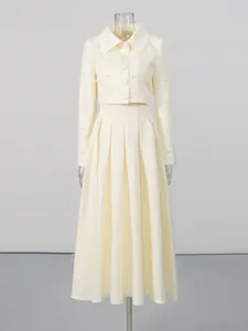 Elegant off-white two-piece set with pearl-beaded cropped jacket and high-waisted pleated skirt