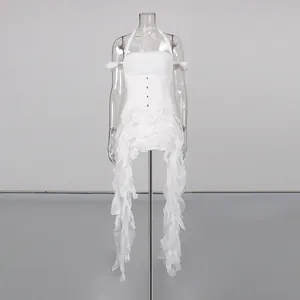Detailed studio view of white halter ruffled dress featuring irregular cascading hemline