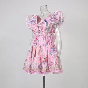 Detail view of pink floral ruffle dress with deep V-neck and cinched waist on mannequin