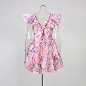 Detailed back view of pink floral ruffle dress with bow tie and layered skirt detail