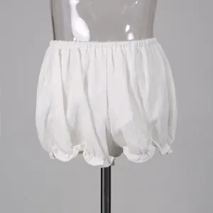 Macro detail of white textured bloomers shorts with elastic waist and ruffled edges