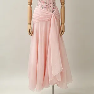 Detail of the elegant pink French style dress featuring a draped waist and layered skirt.