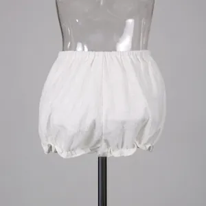 Close-up detail of white ruffled bloomers shorts with vertical texture on mannequin torso