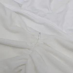 Detailaufnahme eines verdeckten Reißverschlusses an einem weißen Neckholder-Kleid