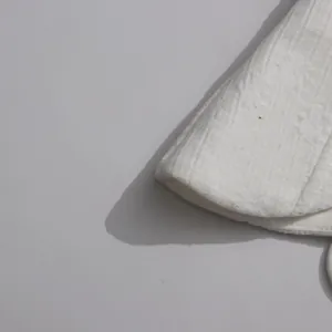Macro detail showing the intricate white textured fabric of this niche designer dress