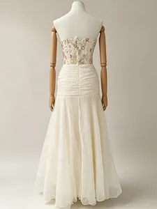 Back view of French elegant evening gown with floral embroidery and ruched skirt