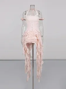 Light pink halter neck dress featuring an irregular ruffled hem and flowing design.