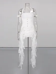 White irregular ruffled tassel dress with halter-neck and corset details on mannequin.