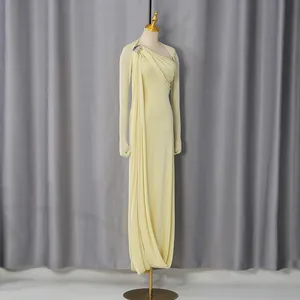 Full-length view of a light yellow one-shoulder elegant evening gown displayed on a mannequin