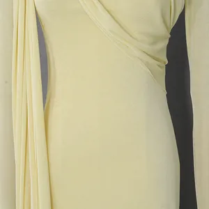 Close-up of pale yellow luxury dress showing fabric texture and elegant draping detail