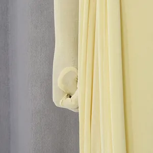 Close-up of yellow glossy fabric and sleeve detail on elegant French luxury dress