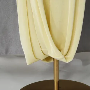 Close-up detail of light yellow French style luxury dress showing elegant draped fabric