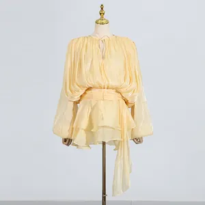 Detailed shot of yellow sweet style pleated dress with tiered ruffles and waist tie