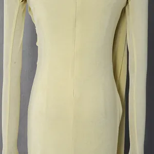Close-up of the pale yellow fabric and seam detail on a French style evening dress