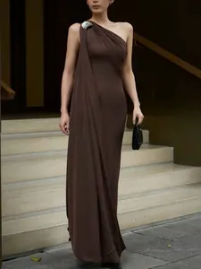 Elegant French style one-shoulder brown maxi dress featuring unique silver brooch detail