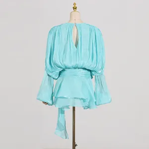 Detailed back view of a light blue pleated mini dress featuring ruffles and lantern sleeves
