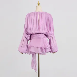 Back view of sweet purple pleated dress with balloon sleeves and ruffled hem