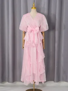 Elegante roze maxi-jurk met ruches en strikceintuur van glanzende stof