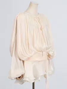 Elegant champagne pleated mini dress featuring lantern sleeves and a stylish tie-neck