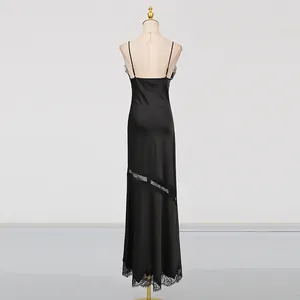 Back view of elegant black satin long slip dress with lace patchwork on mannequin