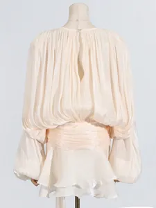 Elegant pleated mini dress with voluminous lantern sleeves and back cutout detail