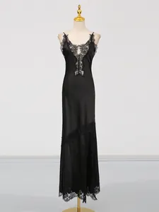 Elegant black lace-trimmed satin slip dress shown on a professional mannequin stand.