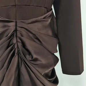 Detailed view of the ruched waist on an elegant brown long-sleeve slim fit dress.