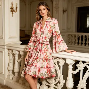 Full view of French style cherry print dress with tiered ruffles and elegant indoor background