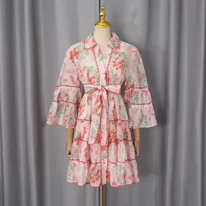 Close-up of a pink cherry print French style shirt dress with tiered ruffled skirt