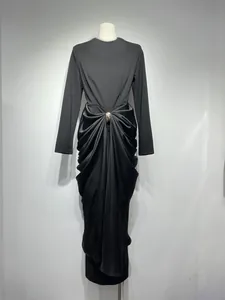 Elegant black long-sleeve slim fit dress featuring a draped front with gold buckle