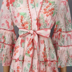 Close-up detail of a French style shirt dress featuring tomato print and ruffled sleeves design