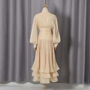 Back view of elegant champagne French-style long-sleeved banquet dress with tiered skirt
