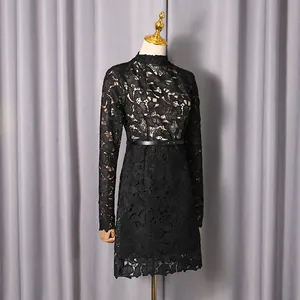Detailed view of elegant black lace mini dress with hollow flower pattern on mannequin
