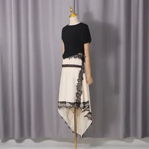 Detailed view of stylish cream high-low skirt with elegant black lace trim on a dress form