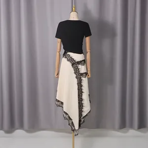 Elegant back view of a fashion set featuring a black top and asymmetric lace midi skirt.