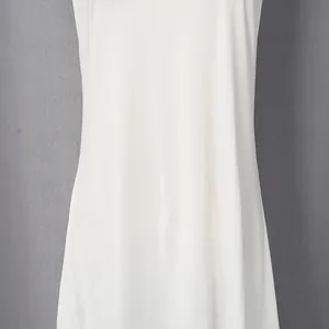 Detailed view of white French-style vacation dress showing its smooth and lightweight fabric texture