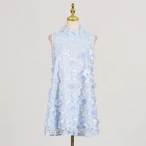 Close-up of exquisite 3D fabric flowers with delicate pearl centers on a light blue dress.