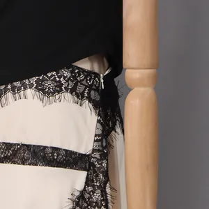 Close-up of elegant black eyelash lace detail and invisible zipper on cream dress
