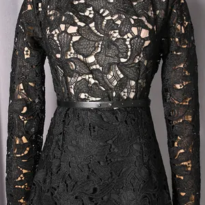 Macro view of intricate black hollow floral lace texture on a slim fit long-sleeved dress