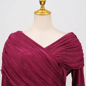 Detail view of the elegant pleated bodice and textured fabric on a magenta dress.