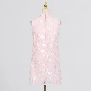 Elegant back view of pink sleeveless mini dress with 3D floral appliques and pearls on mannequin