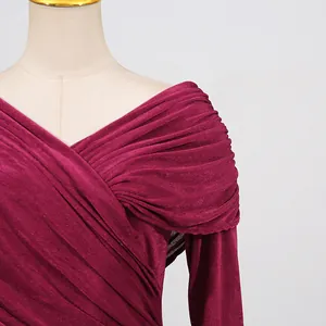 Close-up detail of wine red ruched evening dress with elegant off-shoulder shimmer neckline