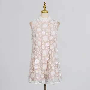 Detail view of sweet white sleeveless dress with 3D floral appliqués and pearl beads