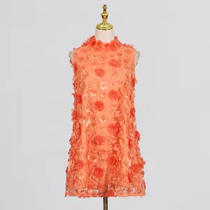 Front view of an orange sleeveless mini dress on a mannequin featuring 3D flower and pearl details