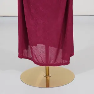 Macro view showing the high-quality pleated fabric texture and elegant hem of the magenta dress