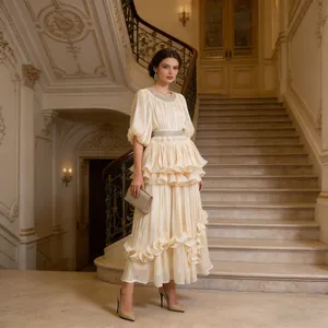 Full-length view of a French court style tiered maxi dress within a grand palace interior
