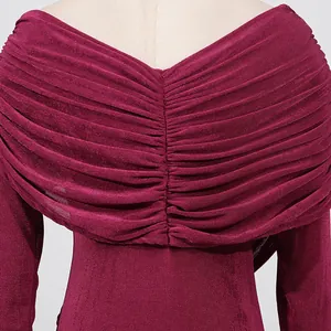 Close-up detail of burgundy pleated long dress featuring elegant ruched design on the back