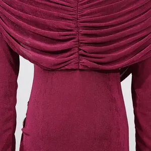 Close-up of the elegant burgundy ruched fabric detail on a slim fit long sleeve dress