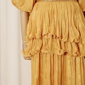 Detailed macro view of golden pleated tiered ruffles on a vintage French court style maxi dress