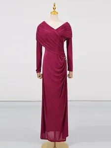 Elegant magenta long-sleeved ruched maxi dress with draped cross-neckline design.